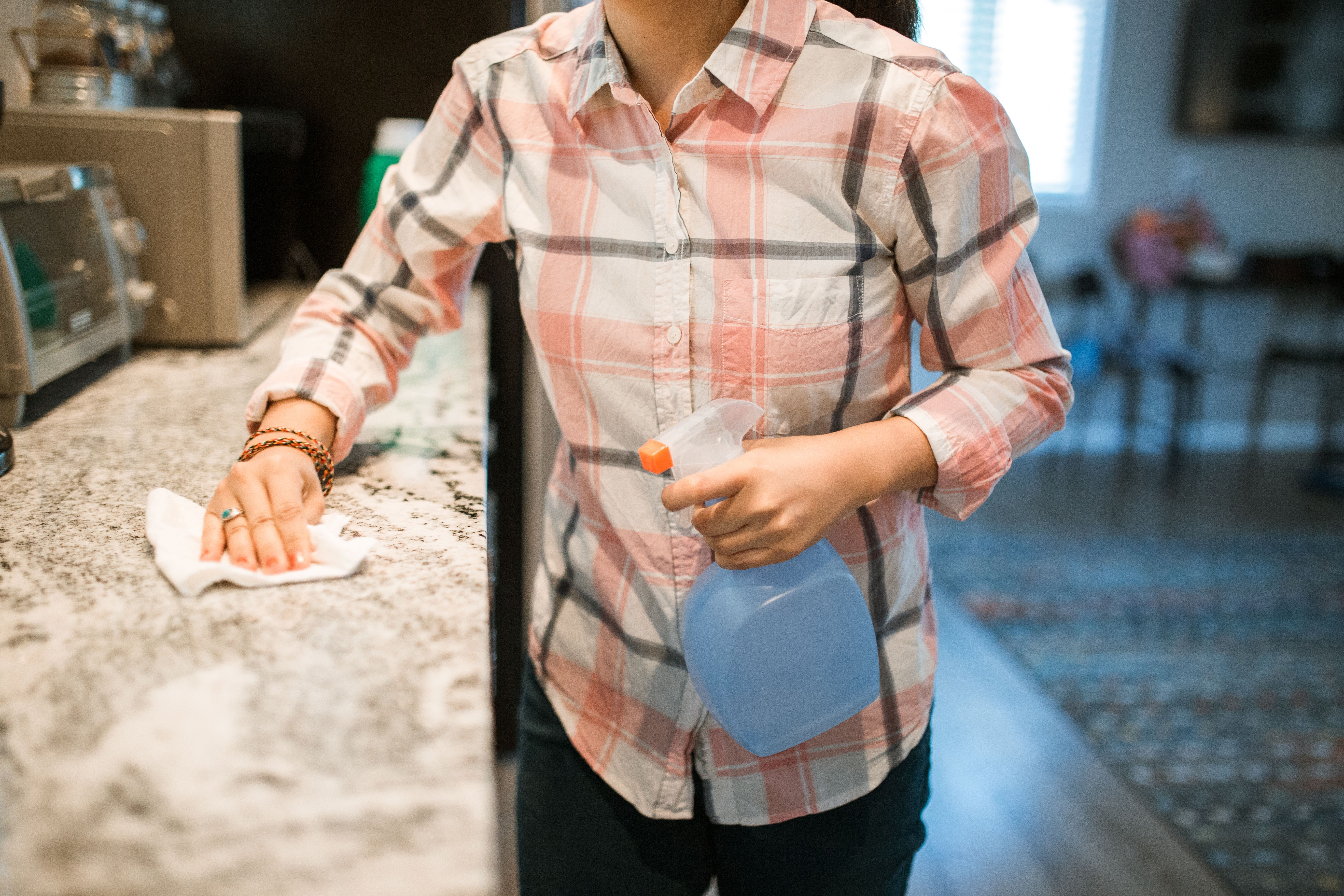 Sagal Green cleaner wiping down a kitchen counter during a residential cleaning